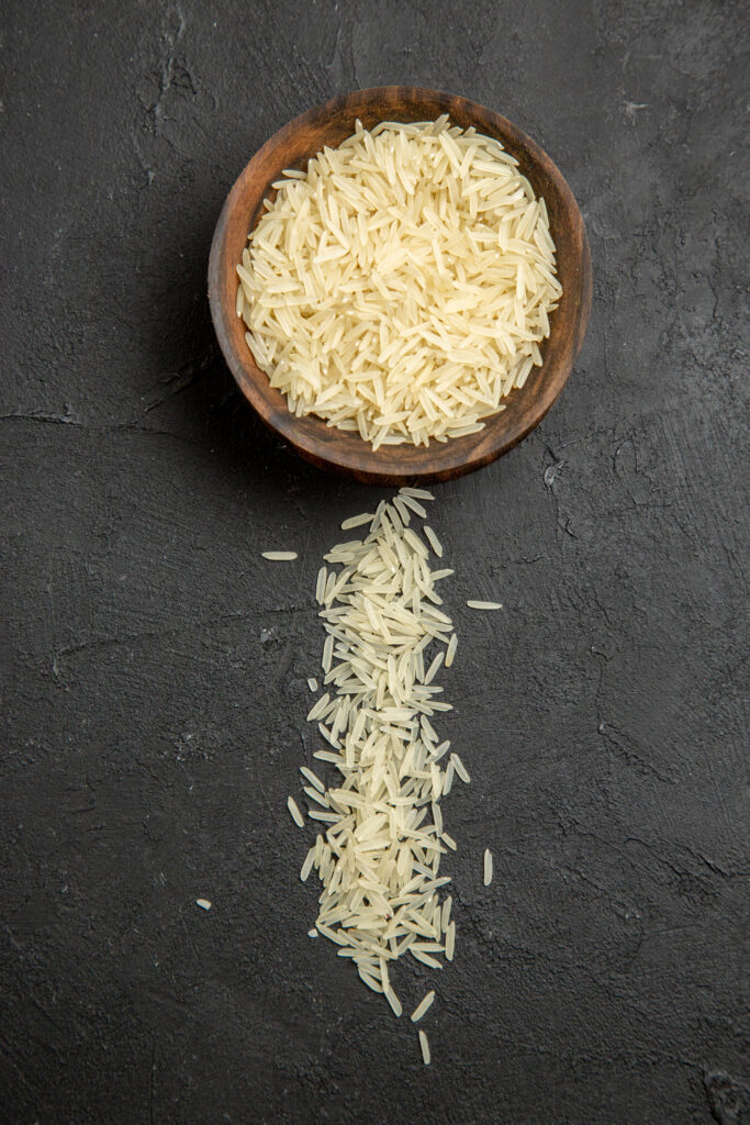 top view raw rice inside brown plate dark surface meal food rice raw 1