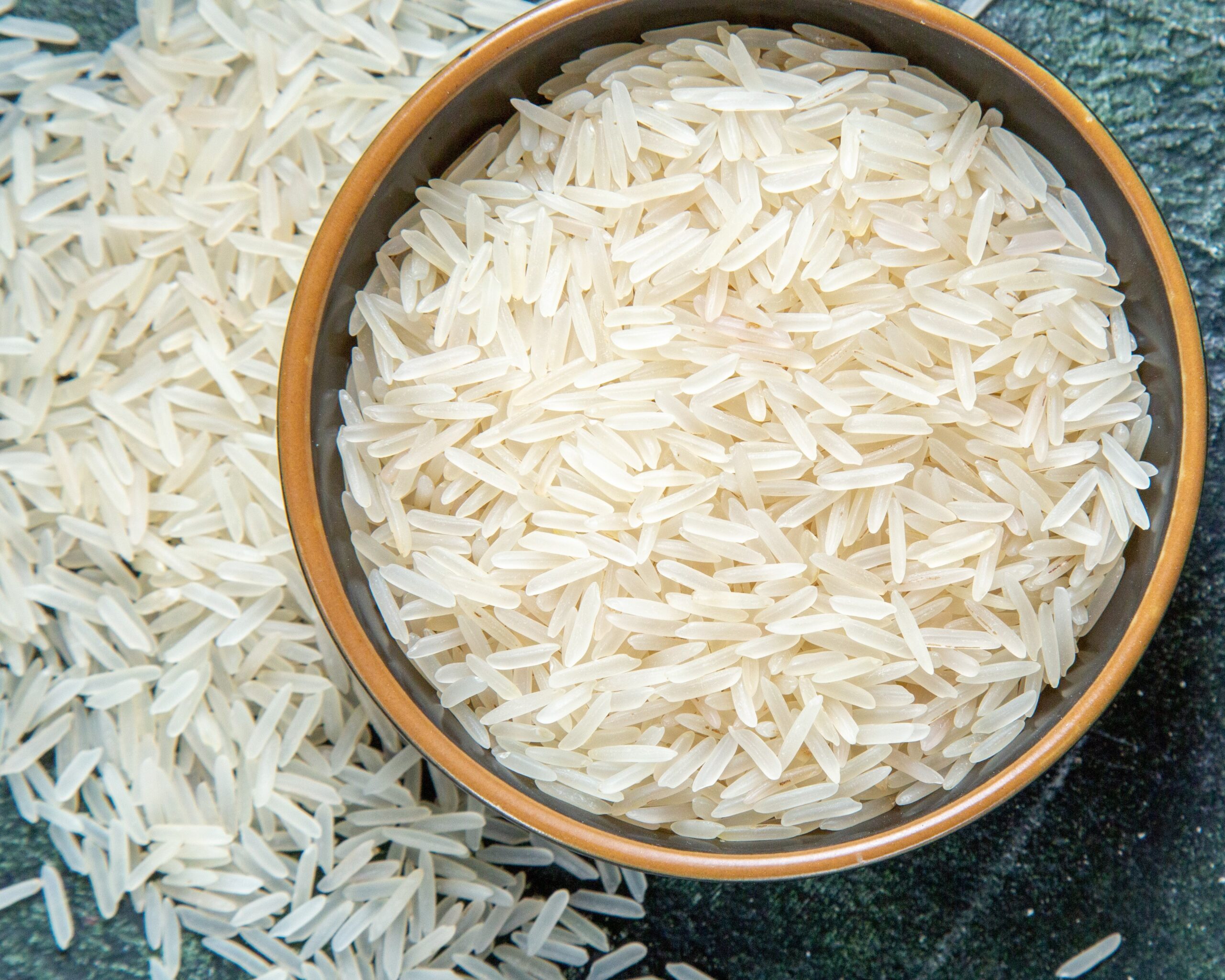 top view raw rice inside plate dark desk 1 scaled